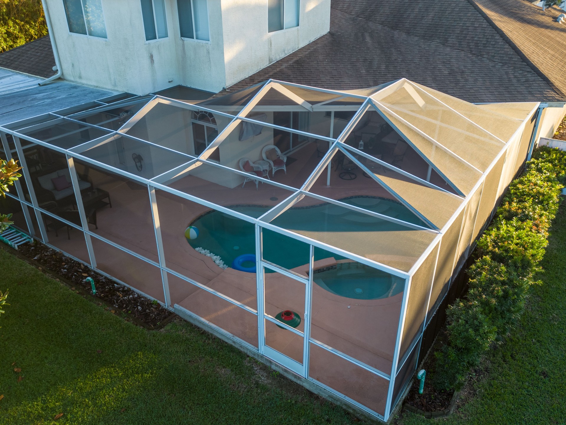 Aerial view of pool screen enclosure surrounded by trees